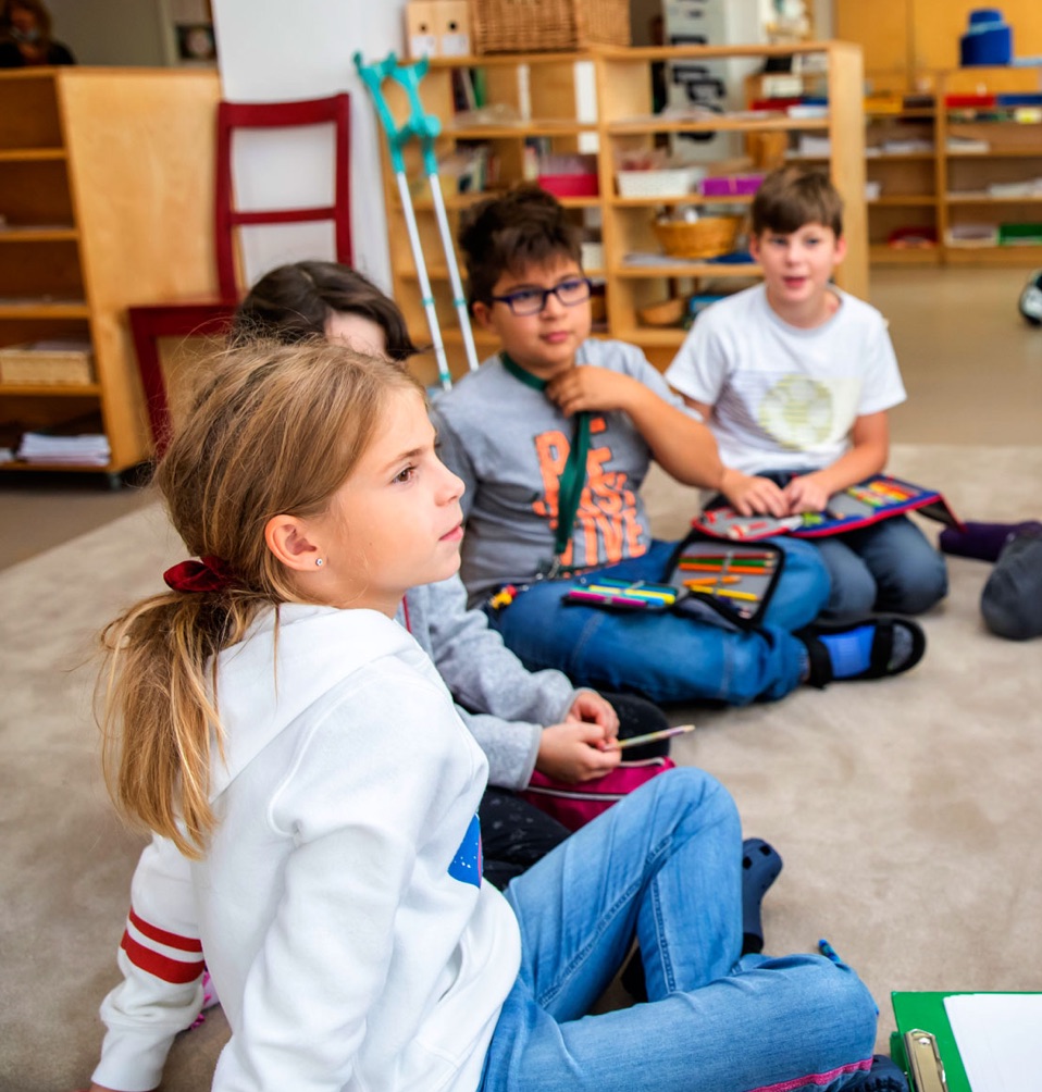 Siitng children in a Montessori classroom